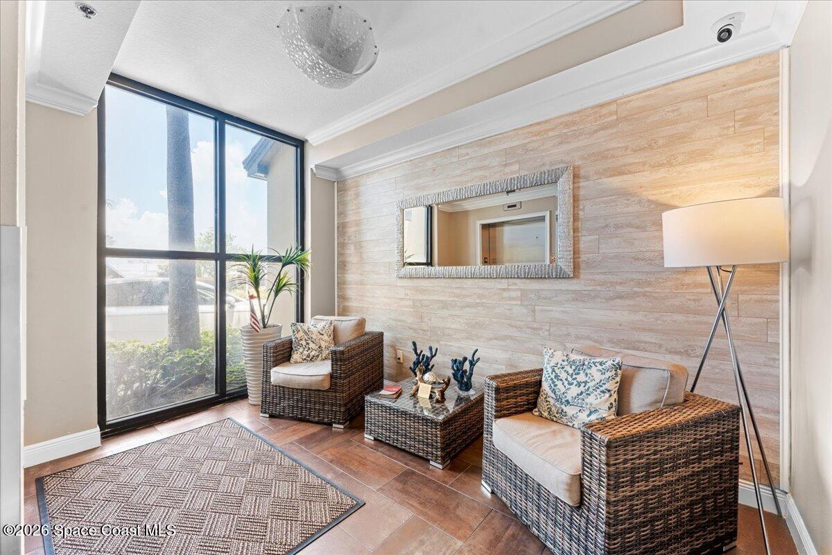 4125 West End Road, Unit 405 Cocoa Beach, FL 32931 - Photo 25 of 44 a living room with furniture and a window
