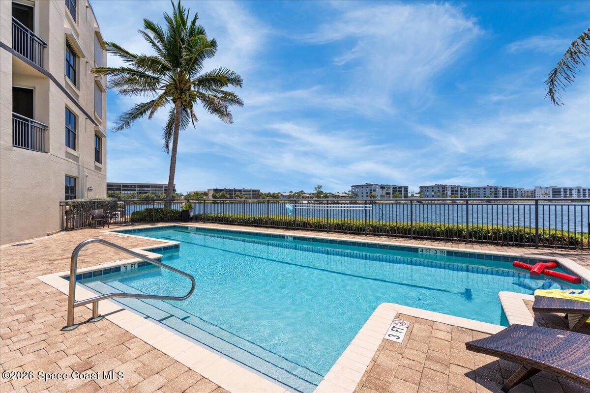 4125 West End Road, Unit 405 Cocoa Beach, FL 32931 - Photo 26 of 44 a view of a swimming pool with lounge chair