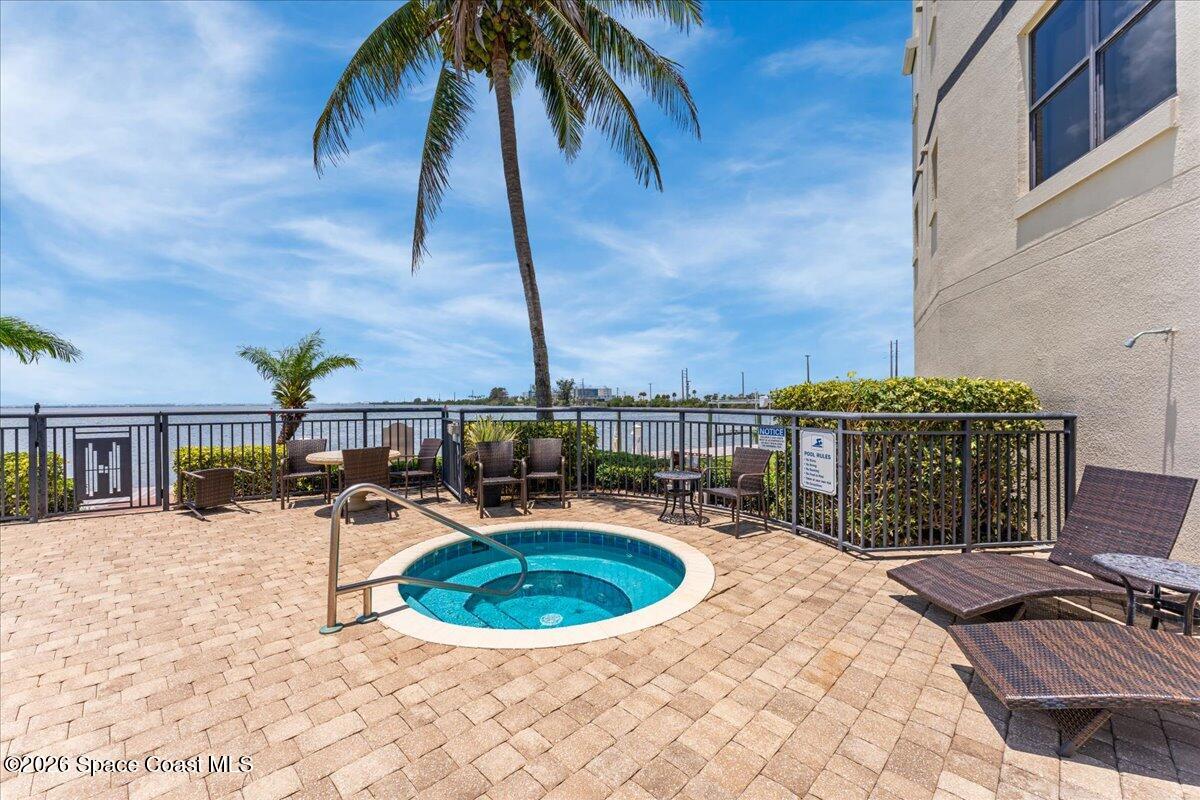 4125 West End Road, Unit 405 Cocoa Beach, FL 32931 - Photo 27 of 44 a view of a chairs and table in the patio