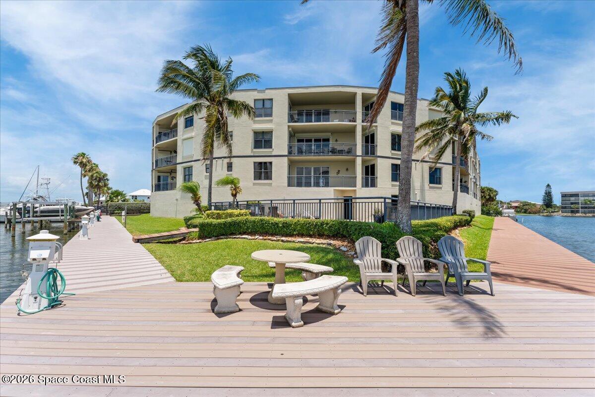 4125 West End Road, Unit 405 Cocoa Beach, FL 32931 - Photo 29 of 44 a front view of a house with garden