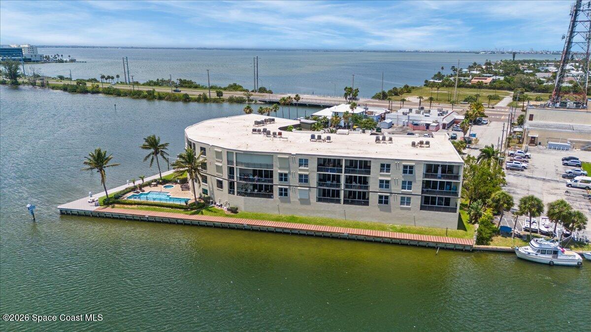 4125 West End Road, Unit 405 Cocoa Beach, FL 32931 - Photo 39 of 44 a view of a swimming pool with lawn chairs