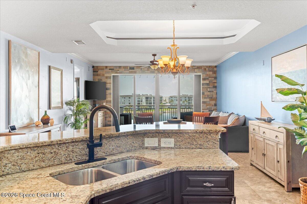 4125 West End Road, Unit 405 Cocoa Beach, FL 32931 - Photo 7 of 44 a kitchen with a granite countertop sink and natural light