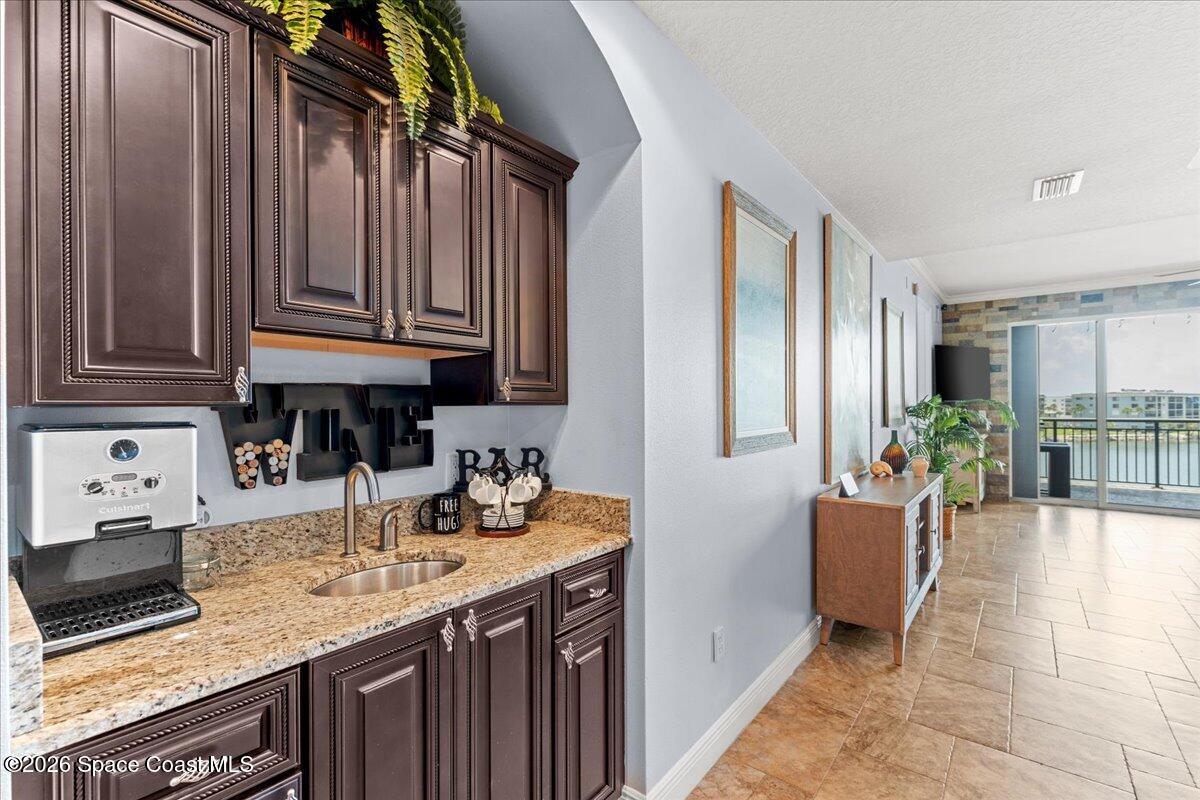 4125 West End Road, Unit 405 Cocoa Beach, FL 32931 - Photo 8 of 44 a kitchen with stainless steel appliances granite countertop a sink dishwasher stove and cabinets