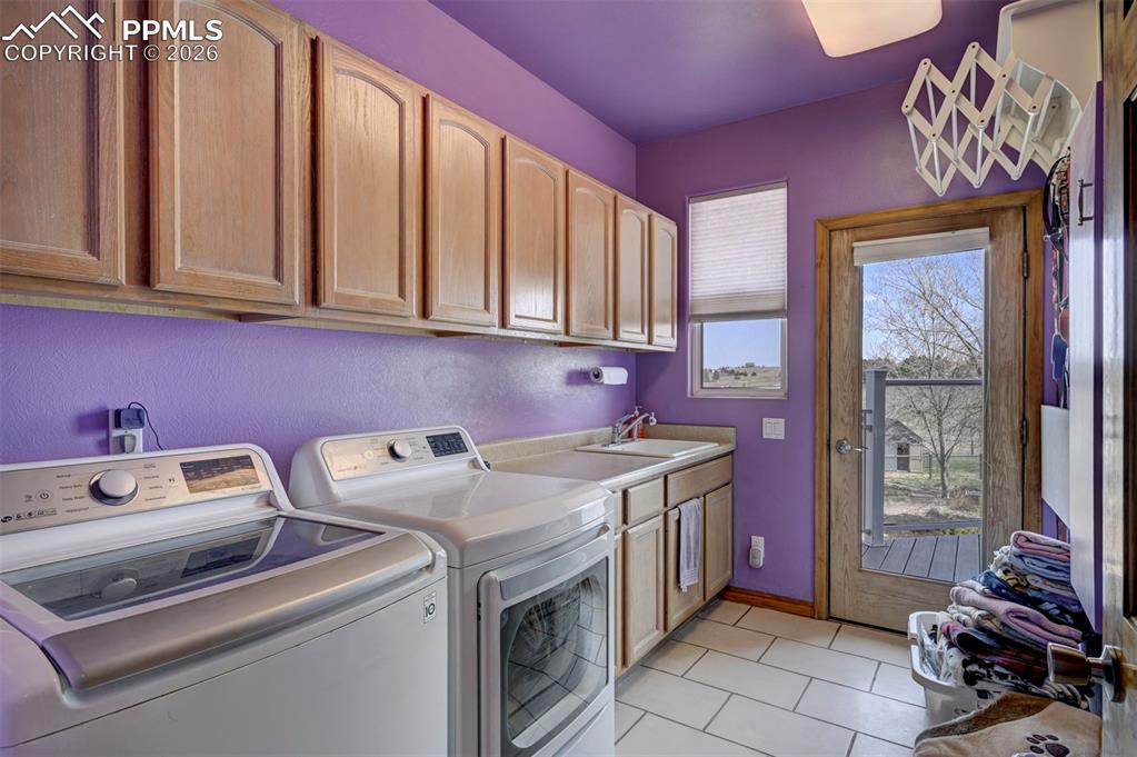 5910 McCart Ranch Circle Elizabeth, CO 80107 - Photo 20 of 50 Laundry room on main floor with utility sink and walk out