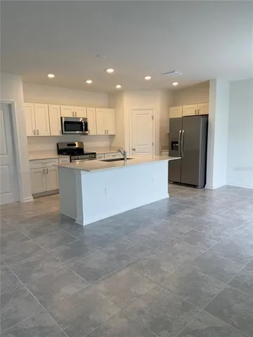 a large kitchen with stainless steel appliances lots of counter top space and cabinets
