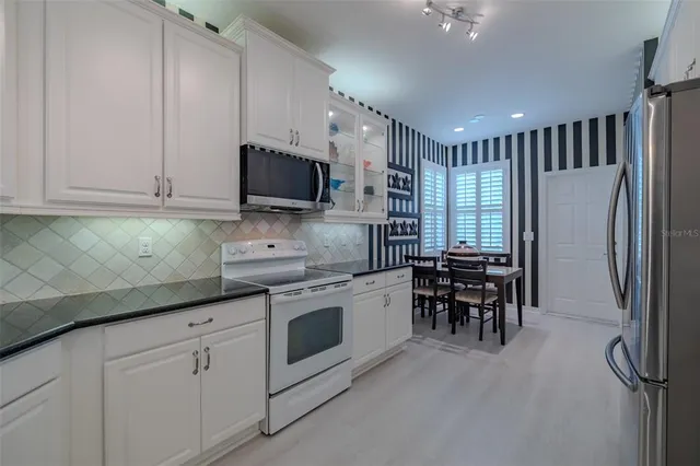 an aerial view of multiple house with outdoor space lake view and trees