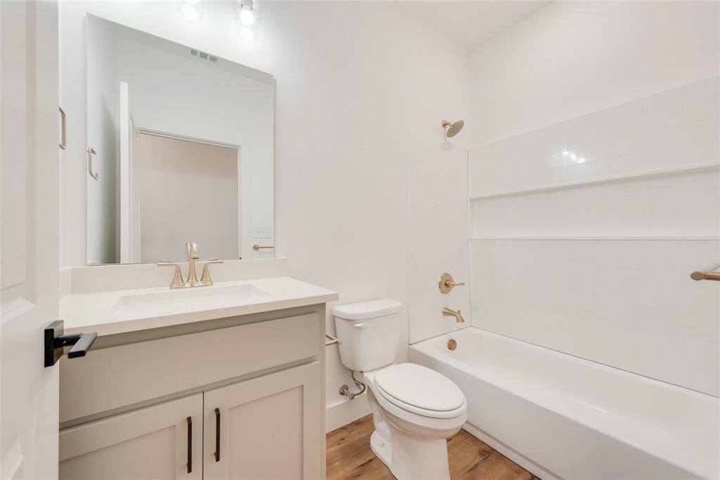 1807 Franklin Street Bonham, TX 75418 - Photo 11 of 13 a bathroom with a sink a toilet and shower