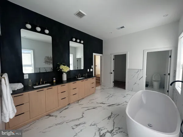 a large bathroom with a double vanity sink and a large mirror