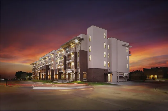 a view of a building with a yard