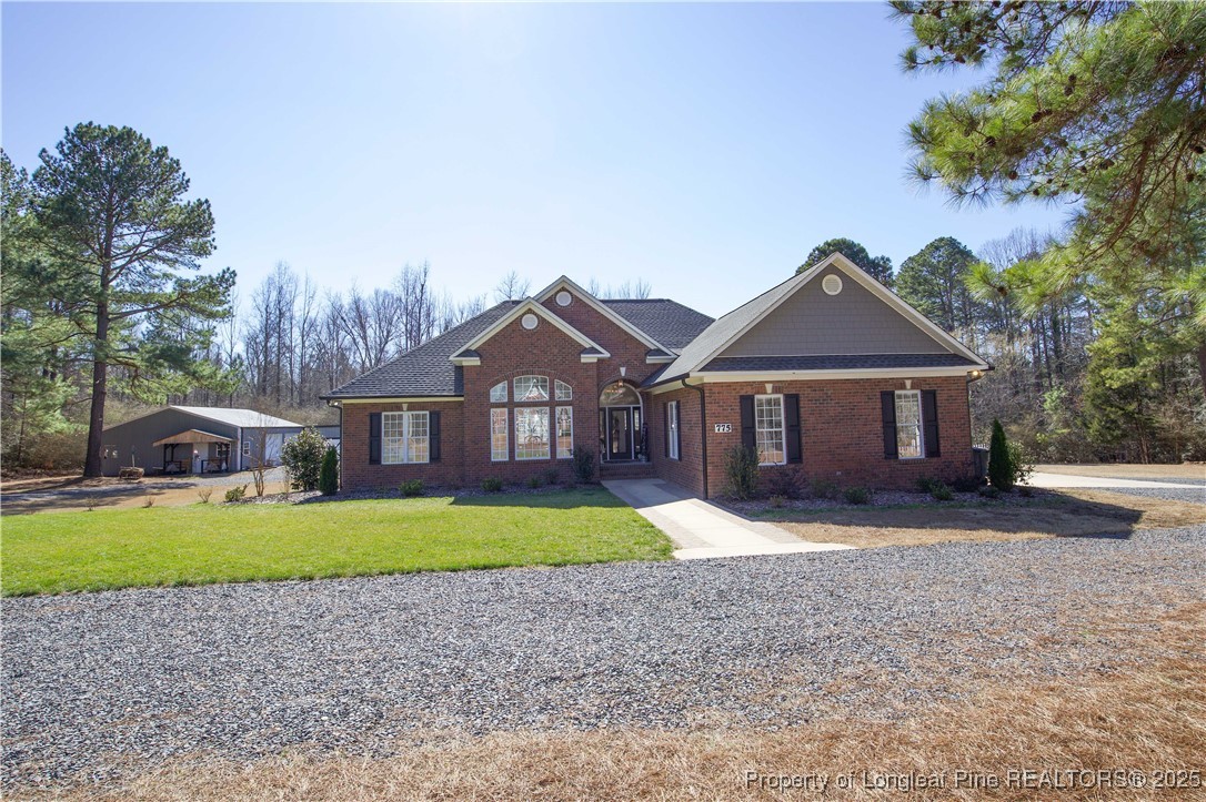 775 Connell Road Carthage, NC 28327 - Photo 1 of 50 a front view of a house with a yard and garage