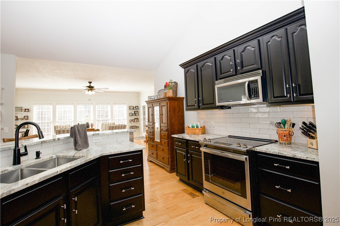 775 Connell Road Carthage, NC 28327 - Photo 11 of 50 a kitchen with stainless steel appliances granite countertop a sink stove and microwave
