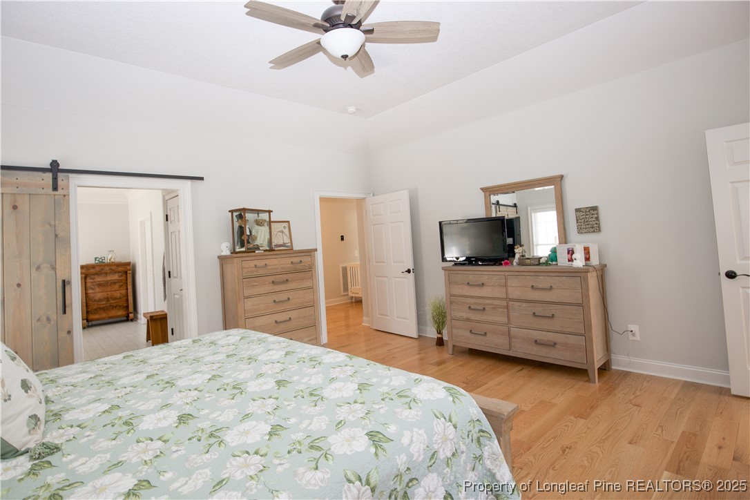 775 Connell Road Carthage, NC 28327 - Photo 13 of 50 a bedroom with a bed and wooden floor