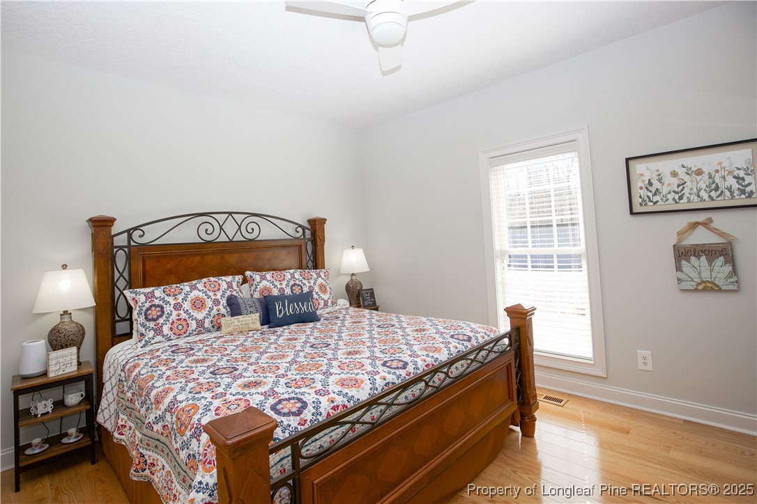 775 Connell Road Carthage, NC 28327 - Photo 15 of 50 a bedroom with a bed and wooden floor