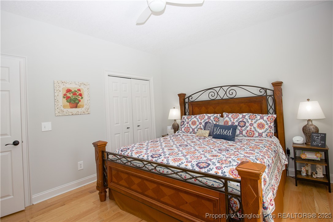 775 Connell Road Carthage, NC 28327 - Photo 16 of 50 a bedroom with a bed and wooden floor