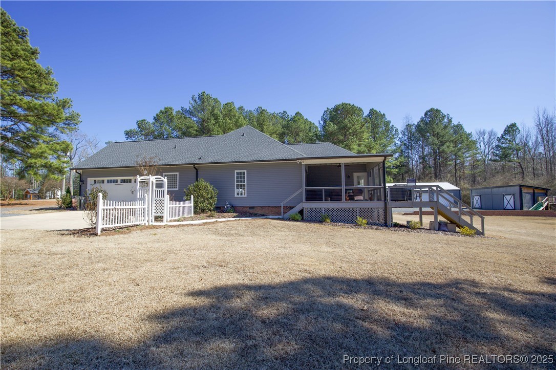 775 Connell Road Carthage, NC 28327 - Photo 32 of 50 a front view of a house with a garden and trees