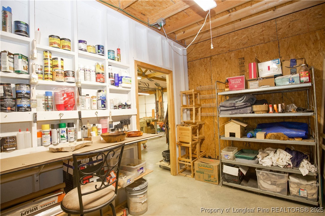 775 Connell Road Carthage, NC 28327 - Photo 48 of 50 a utility room with lots of clutter and cabinets