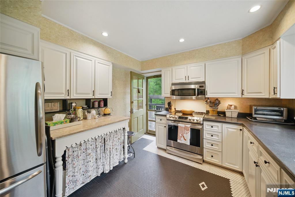 351 Franklin Road Denville, NJ 07834 - Photo 12 of 45 a kitchen with stainless steel appliances granite countertop a stove and a refrigerator