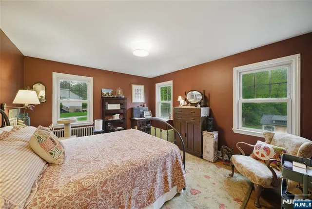 a bedroom with a large bed and a large window