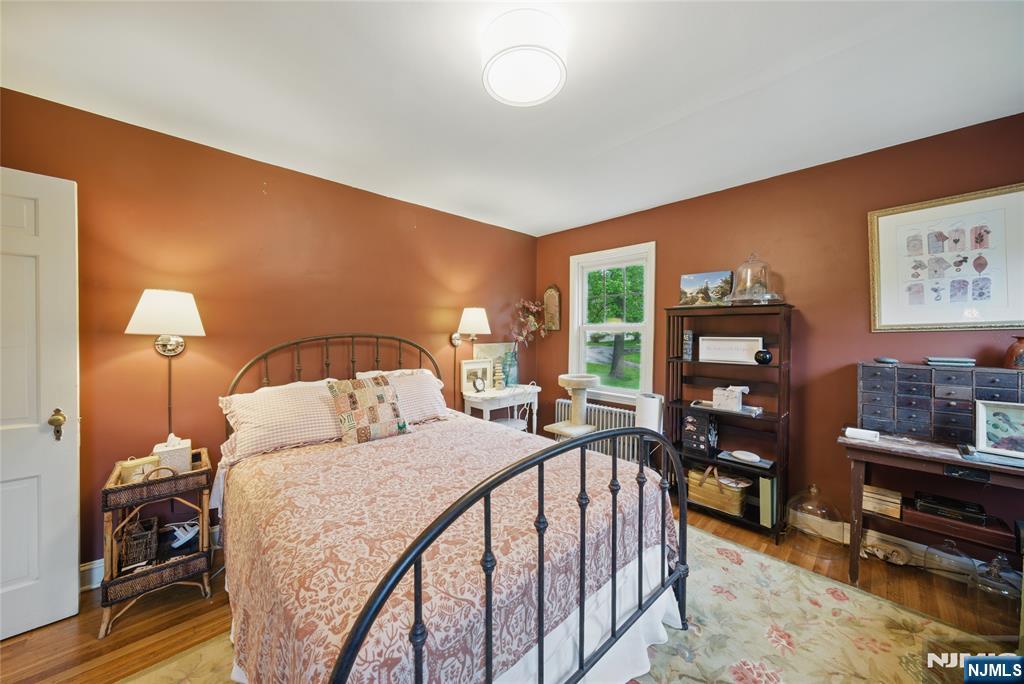 351 Franklin Road Denville, NJ 07834 - Photo 18 of 45 a bedroom with a bed and a flat tv screen on dresser