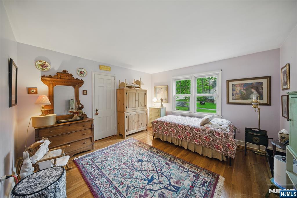 351 Franklin Road Denville, NJ 07834 - Photo 21 of 45 a bedroom with a bed and wooden floor