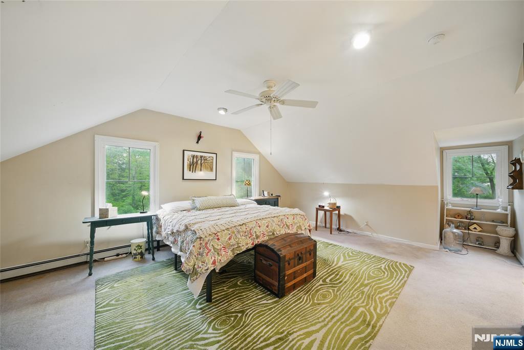 351 Franklin Road Denville, NJ 07834 - Photo 26 of 45 a spacious bedroom with a bed a window and couch