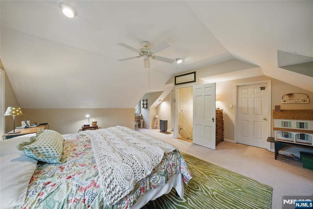 351 Franklin Road Denville, NJ 07834 - Photo 27 of 45 a spacious bedroom with a bed and a book shelf