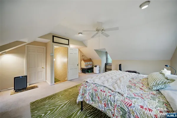 a bedroom with a bed and a mirror