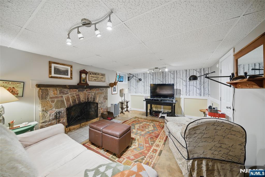 351 Franklin Road Denville, NJ 07834 - Photo 30 of 45 a living room with furniture and a fireplace