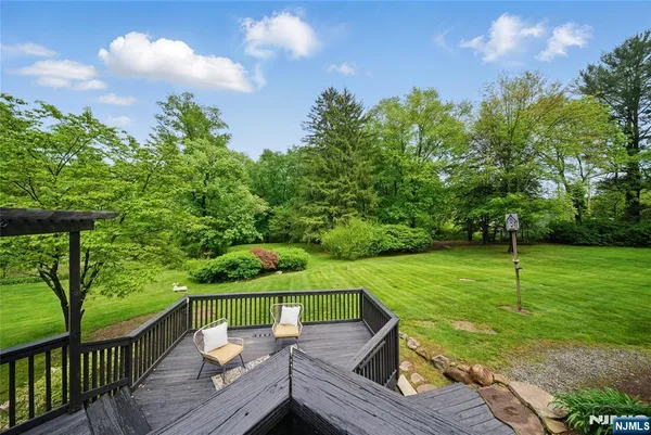 a view of a deck with chairs and a yard