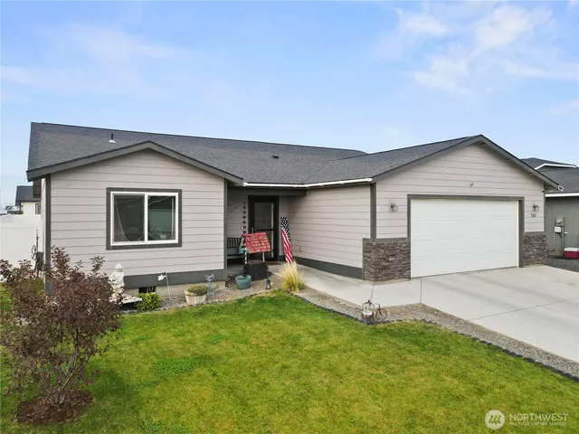 a view of a house with a yard and sitting area