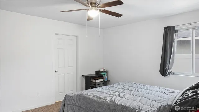 a bedroom with a bed and a chandelier