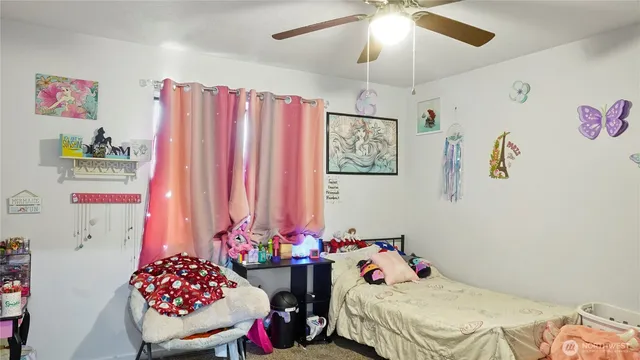 a bathroom with a sink a toilet and shower curtain