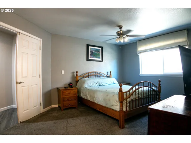 a bedroom with a bed lamp closet and window