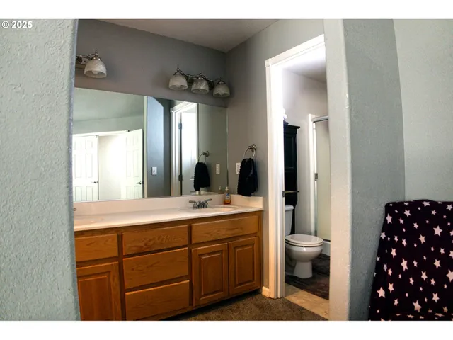 a bathroom with a sink vanity granite and a mirror