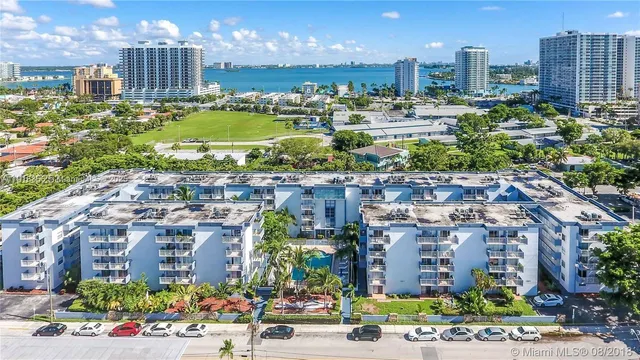 a view of a city with lush green forest