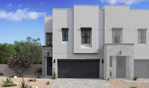 a front view of a house with plants