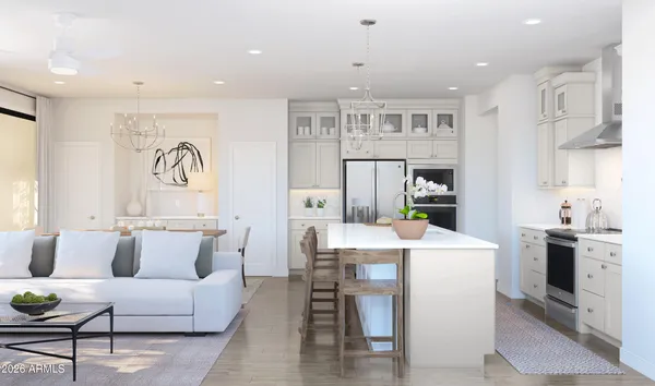 a kitchen with stainless steel appliances kitchen island granite countertop a dining table chairs and white cabinets