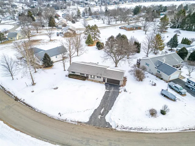a open kitchen with stainless steel appliances granite countertop a refrigerator a stove and a wooden floors