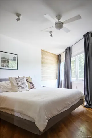 a bedroom with a large bed and a large window