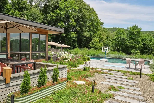 swimming pool view with a seating space