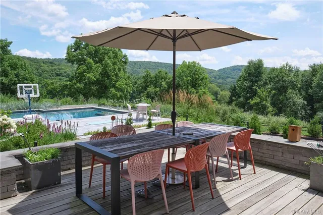 a backyard of a house with table and chairs