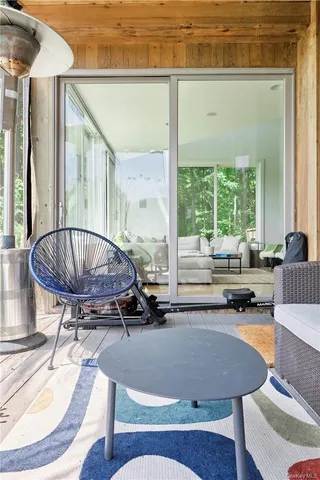 a living room with a table and a chandelier