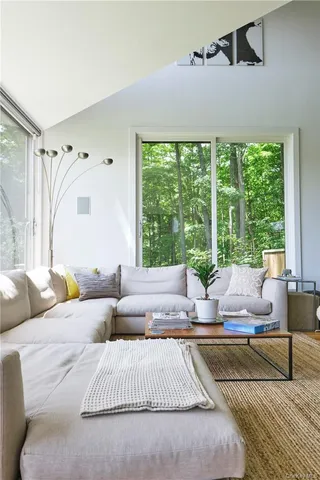 a bedroom with a bed and a large window with balcony view