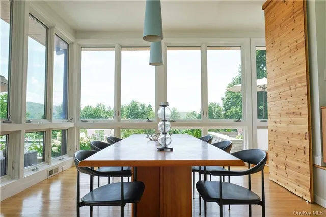 a view of an outdoor dining space with a table and chairs