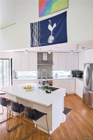 a kitchen with stainless steel appliances granite countertop a sink and a stove