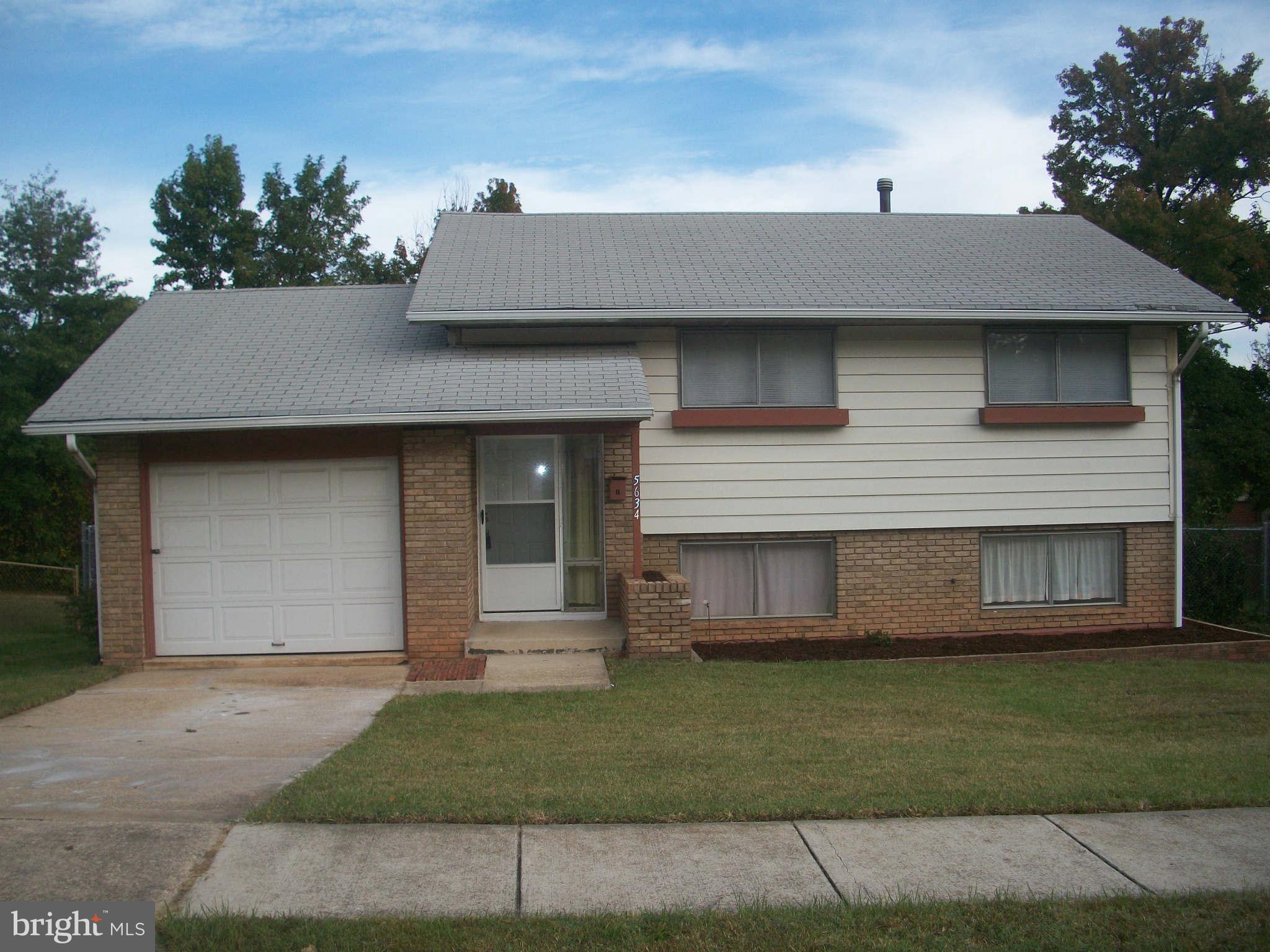 5634 Westgate Road Lanham, MD 20706 - Photo 1 of 12 a front view of a house with a garden