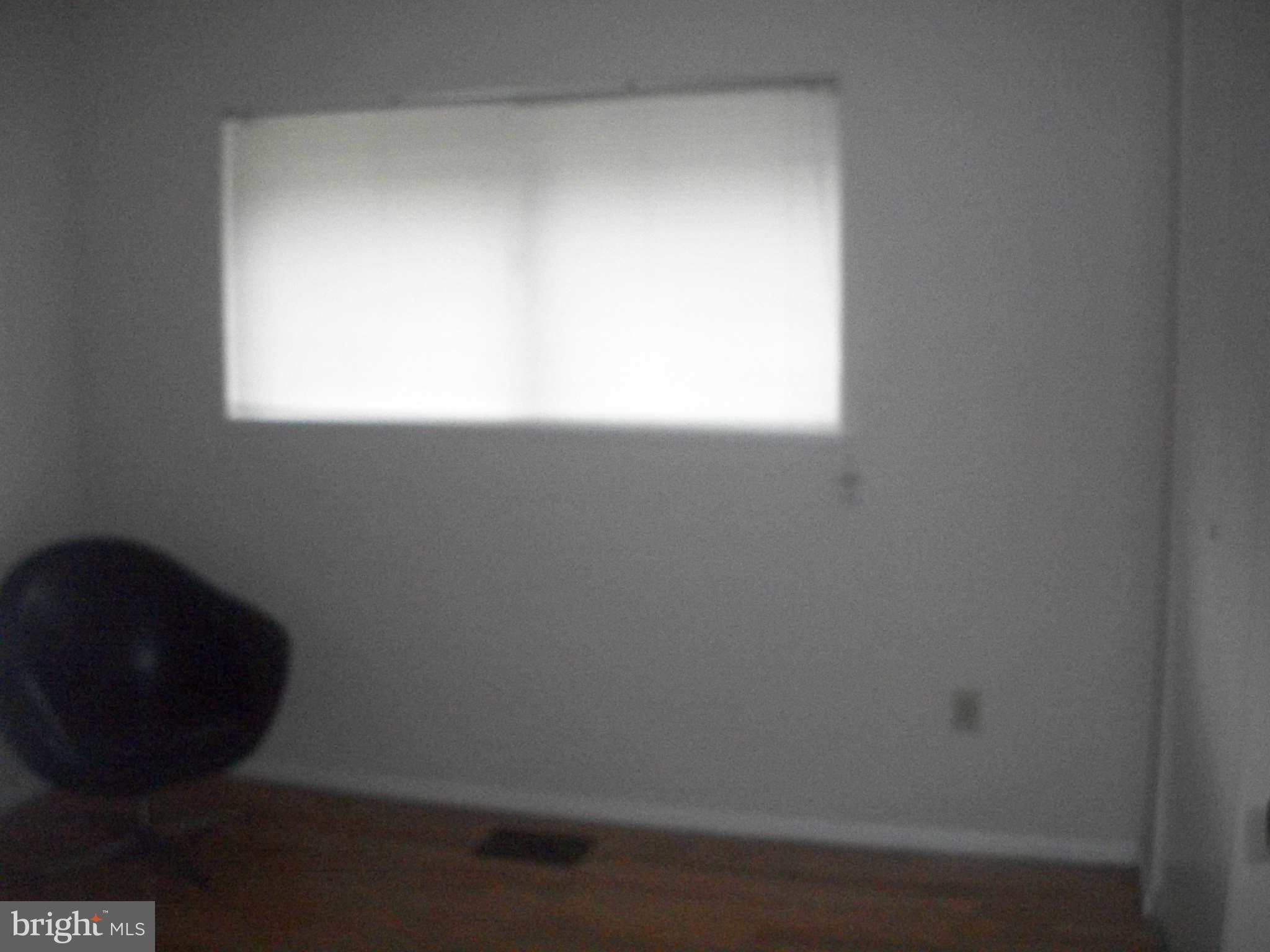 5634 Westgate Road Lanham, MD 20706 - Photo 5 of 12 a view of a small space with wooden floor and a window
