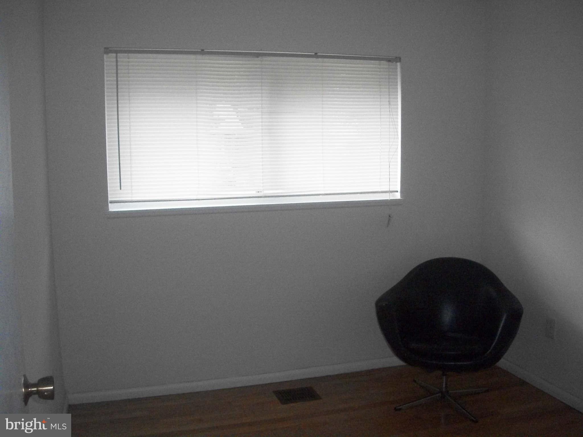 5634 Westgate Road Lanham, MD 20706 - Photo 6 of 12 a view of a small space with wooden floor and a chair