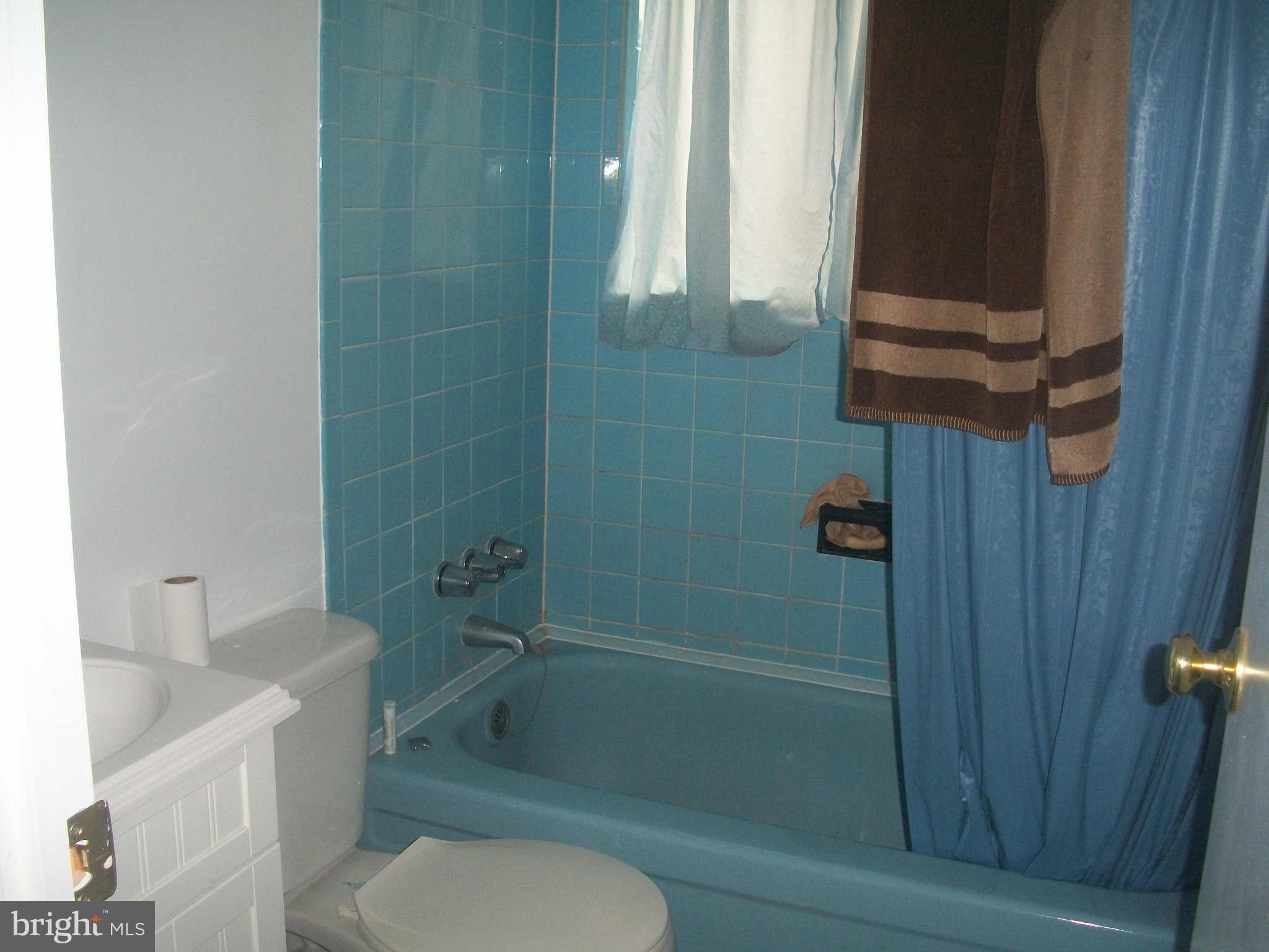 5634 Westgate Road Lanham, MD 20706 - Photo 8 of 12 a bathroom with a toilet and a shower