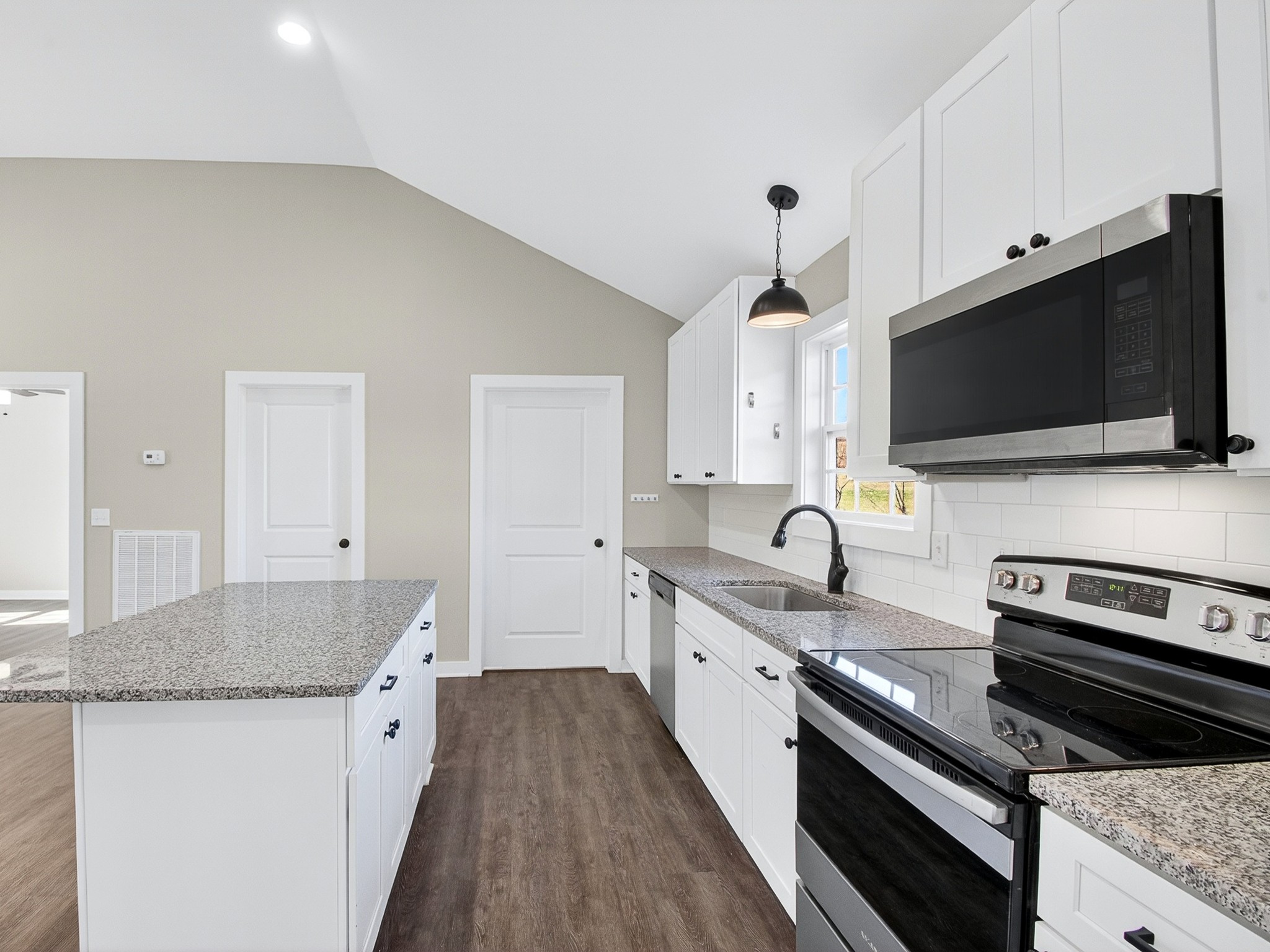 621 Womack Road Bethpage, TN 37022 - Photo 17 of 50 a kitchen with granite countertop a stove and a sink